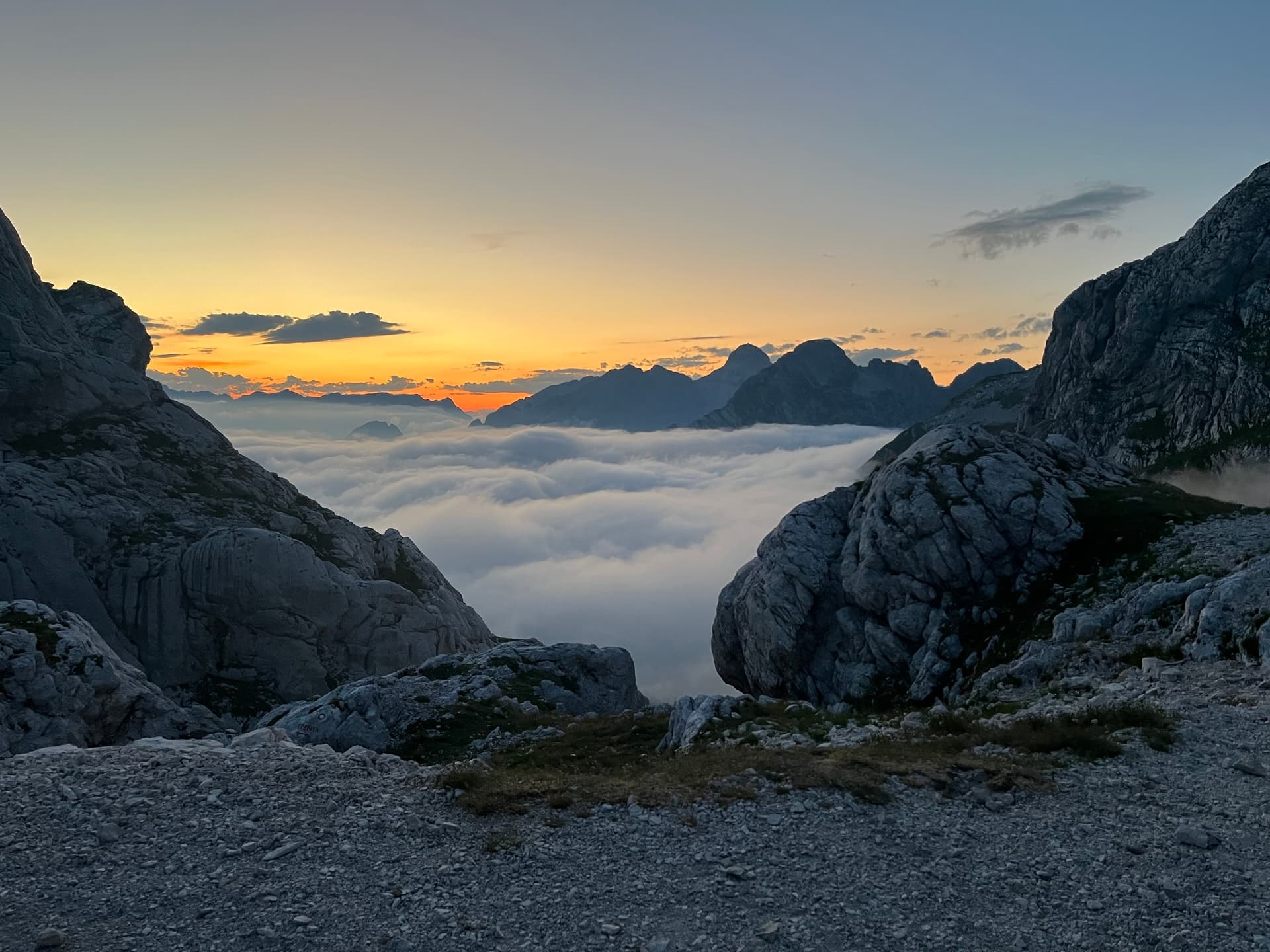 Sea of clouds filling a mountain valley at sunset