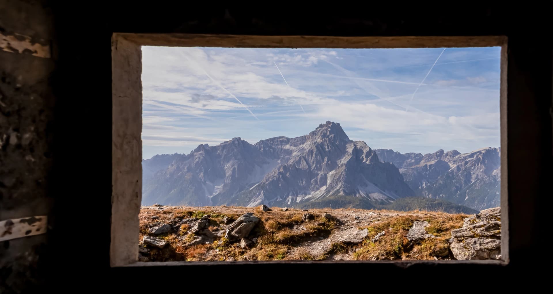 View from window of remains of military bunker First World War, mount Helm (Monte Elmo). Looking at summit Dreischusterspitze in mountain range of untamed Sexten Dolomites, South Tyrol, Italy, Europe